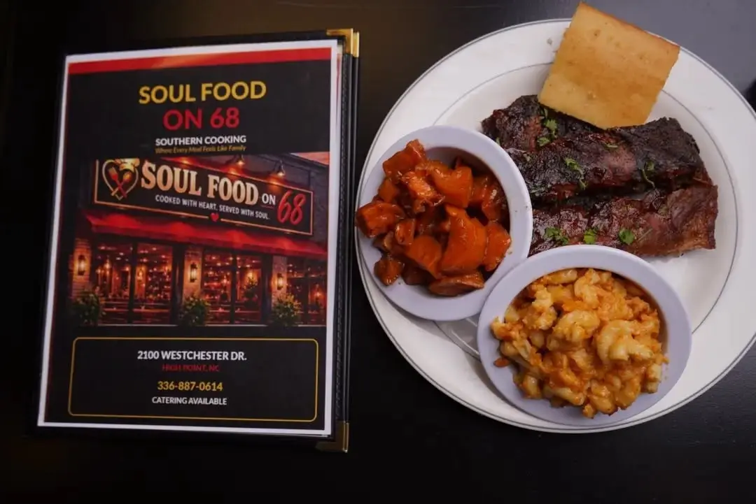 A plate of BBQ ribs with candied yams, macaroni and cheese, and cornbread beside the Soul Food on 68 menu
